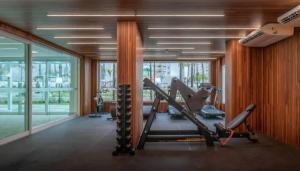a gym with cardio equipment in a room with windows at Salinas Exclusive Resort in Salinópolis