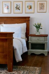 a bedroom with a bed and a table with a vase on it at Vila Štiavnica in Banská Štiavnica