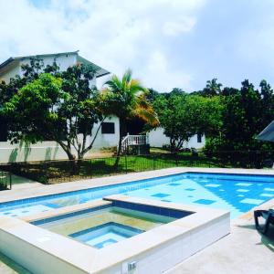 a swimming pool in front of a house at Finca Bello Terruño, Anapoima, Descanso, Naturaleza in Anapoima