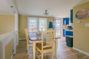 a kitchen and dining room with a table and chairs at 34 Dillingham Avenue Sandwich Cape Cod - Aloha in Sandwich