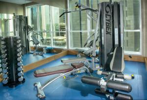 a gym with cardio equipment in a large room at TRYP by Wyndham Abu Dhabi City Center in Abu Dhabi