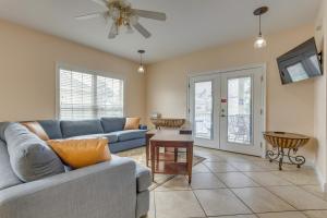 a living room with a couch and a table at 1 Mi to Beach Access Spacious Orange Beach Duplex in Orange Beach