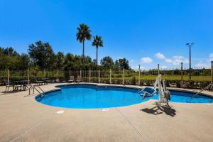 a swimming pool with a slide in a park at Best Western Houma Inn in Gray