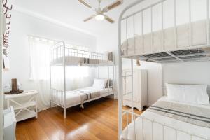 a bedroom with white bunk beds and a desk at The Seaside Cobbler in Rye
