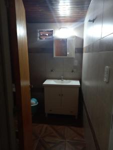 a small bathroom with a sink and a mirror at Departamento LA LILI in Uspallata