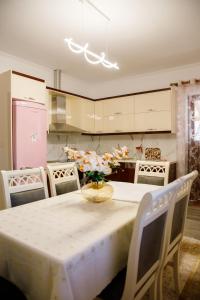 uma cozinha com uma mesa com um vaso de flores em The Luxe Apartments em Gjirokastër
