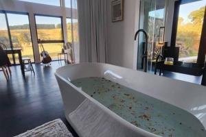 a white bath tub with some debris in a room at Shibui Lilydale Luxury Romance in Lilydale
