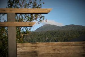 a wooden fence with a view of a mountain at Shibui Lilydale Luxury Romance in Lilydale