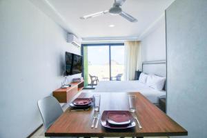 a hotel room with a table and a bed at One Paralia 405 in Playa del Carmen