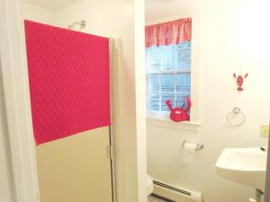 a bathroom with a shower and a toilet and a sink at 14 Capri Lane Chatham Cape Cod - The Cape House in Chatham +23 photos