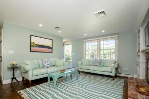 a living room with two couches and a table at Newly updated home sleeps 7, AC, free WIFI, half mile to town in Chatham
