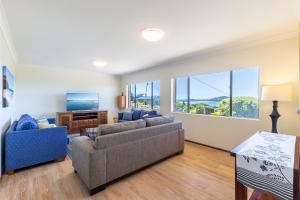 a living room with two couches and a tv at 10 Garuwa Street - Fabulous Fingal Bay water views in Fingal Bay