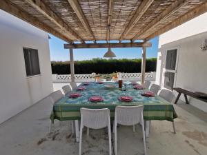 a table and chairs on the patio of a house at Casas na Lagoa - Carvalhal in Carvalhal