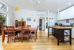a kitchen and dining room with a table and chairs at The Yellow Door Inverloch in Inverloch