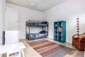 a bedroom with a bunk bed and a table at The Yellow Door Inverloch in Inverloch