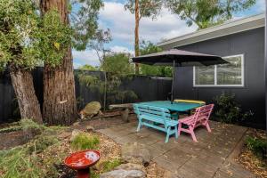 a picnic table and an umbrella on a patio at The Yellow Door Inverloch in Inverloch