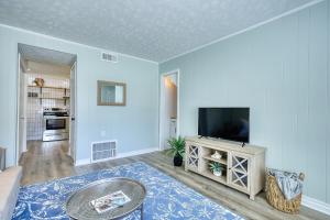 a living room with a flat screen tv at Coastal Cottage 1/2 mile from Covington Square in Covington