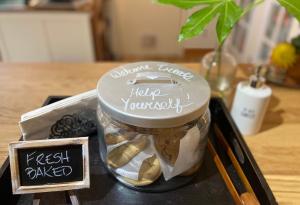 a jar of food sitting on a table with a sign at Wisteria Guest House in Ganges