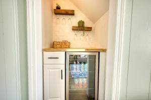 a kitchen with a refrigerator with drinks in it at Coastal Cottage 1/2 mile from Covington Square in Covington