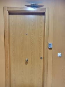 a wooden door in a room with a ceiling at Casa de Maria in Santiago de Compostela