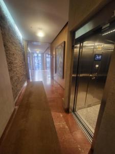 an empty hallway with an elevator in a building at Casa de Maria in Santiago de Compostela