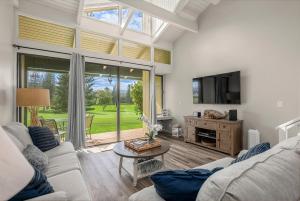 a living room with a couch and a tv at Kuilima Estates West 120 in Kahuku