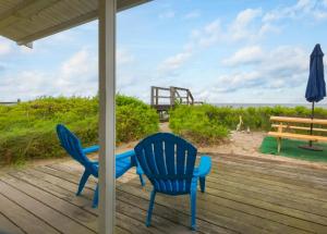 two chairs and a table and a bench on a porch at 131 #4 North Shore Boulevard East Sandwich - Waters Edge #4 in East Sandwich