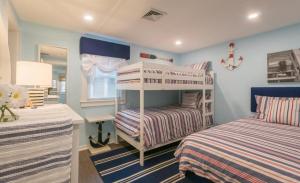 a bedroom with two bunk beds and a desk at 131 #4 North Shore Boulevard East Sandwich - Waters Edge #4 in East Sandwich