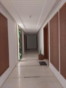 an empty corridor of a building with a hallway at Appartement Residence Essayedi Sousse in Port El Kantaoui