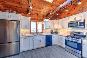 a kitchen with white cabinets and a wooden ceiling at 10 Chadwell Avenue Sandwich - Cape Cod in Sandwich +21 photos
