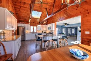 a kitchen with white cabinets and a wooden ceiling at 10 Chadwell Avenue Sandwich - Cape Cod in Sandwich