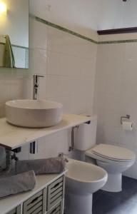 a bathroom with a sink and a toilet at Casa Tía Rosa. in Adeje