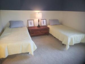 a room with two beds and a lamp in it at 4BR Private Dock, Warm Spring Canal, Kayaks, Canoe in Hudson