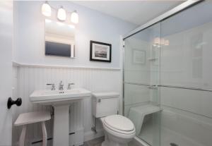 a bathroom with a toilet and a sink and a shower at 177 Old Stage Road Centerville - - Family Tides in Centerville +18 photos