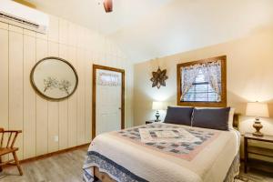 una camera da letto con un letto e uno specchio a parete di Lakehills Cabin with Fire Pit, Near Medina Lake! a Lakehills
