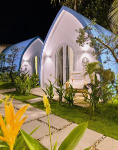 two igloo homes in a garden at night at Malis Homestay in Trà Vinh