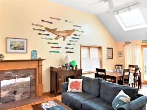 a living room with a couch and a fireplace at 122 Tracy Lane Brewster Cape Cod - Jack's Little Cape House in Brewster