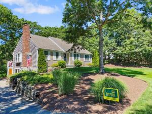 a house with a sign in front of it at 122 Tracy Lane Brewster Cape Cod - Jack's Little Cape House in Brewster
