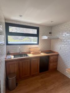 a kitchen with a sink and a window at Desierto Suites in El Chalten +52 photos