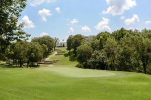 a view of a golf course with a green at Cozy Top Floor 2BR Condo with View and Amenities!! in Branson
