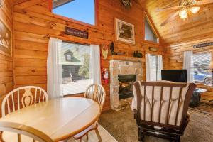 a dining room with a table and a fireplace at Cuddly Bear Hideaway in Pigeon Forge +20 photos