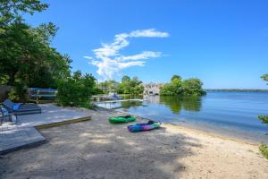 a beach with two canoes on the shore of a lake at Relax by the Lake: Private Beach Views in Centerville +45 photos