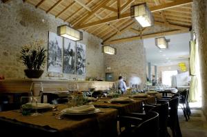 a dining room with tables and chairs with people in the background at Casas do Regato in Castelo Branco