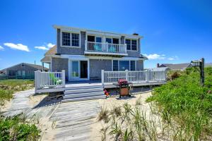 a house on a boardwalk in front of a beach at 197 North Shore Boulevard East Sandwich - Cape Cod in East Sandwich