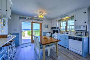 a kitchen with a wooden table and a dining room at 197 North Shore Boulevard East Sandwich - Cape Cod in East Sandwich