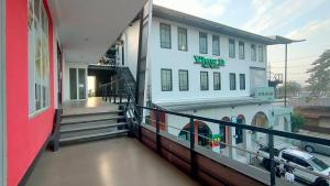 a building with a car parked in front of it at View Dee BKK Airport Residence in Ban Khlong Prawet