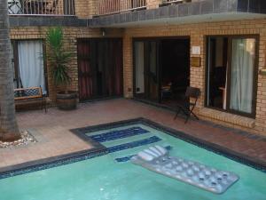 a swimming pool with two balls in the water at Uitsigpark Guest@home4U in Centurion