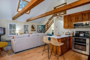 a kitchen and living room with a couch and a table at Turtle Dreams: Cozy Cape Cod Bayside Retreat in Eastham +35 photos