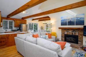 a living room with a couch and a fireplace at Turtle Dreams: Cozy Cape Cod Bayside Retreat in Eastham