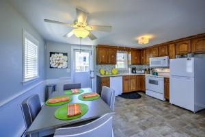 a kitchen with a table and a white refrigerator at 355 B Phillips Road Sagamore Beach - Cape Cod in Sagamore Beach